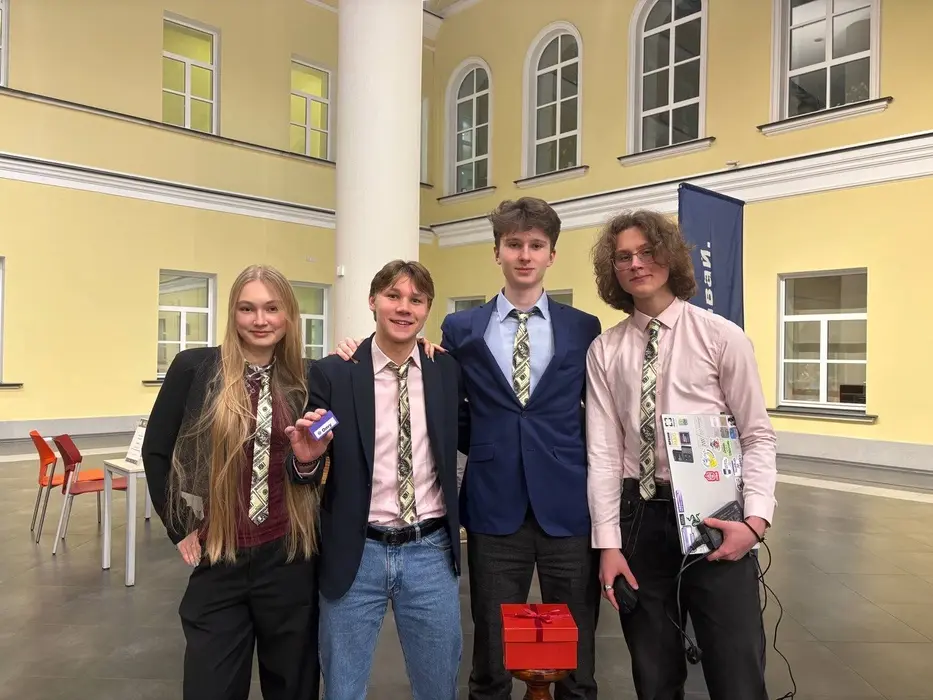 Four teammates wearing dollar-print ties after case competition finals